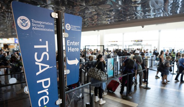 Passengers line up at a TSA checkpoint at Luis Munoz Marin International Airport in Carolina, Puerto Rico, March 27, 2026.