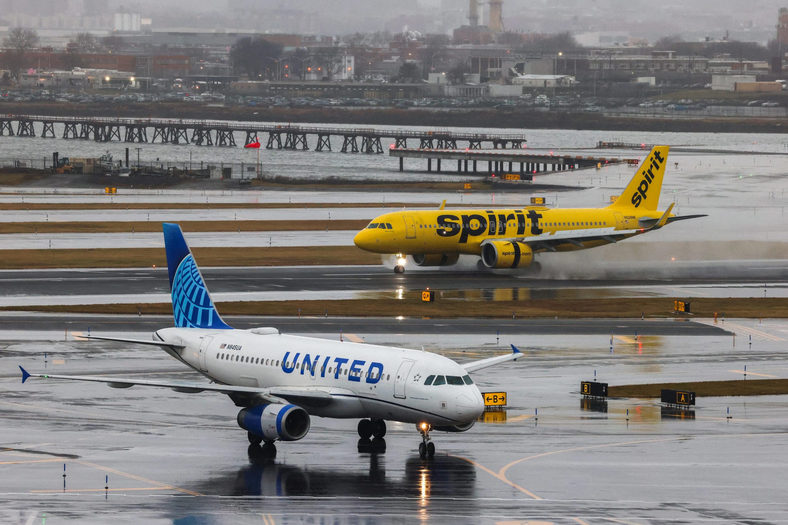 An Airbus A320 passengers aircraft of Spirit airlines arriving from Miami is pictured while an Airbus A319 of United airlines arrived from Denver are seen at LaGuardia Airport on January 9, 2024