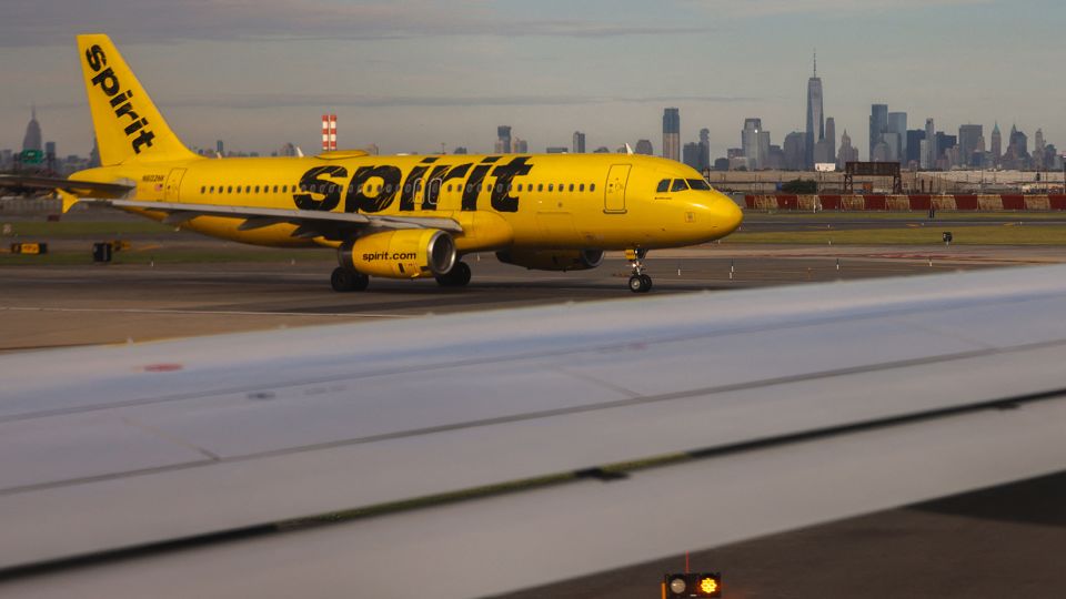The lower Manhattan skyline looms at a distance as a Spirit airlines Airbus A320 preparing for takeoff, Newark Airport in New Jersey in May 2024.