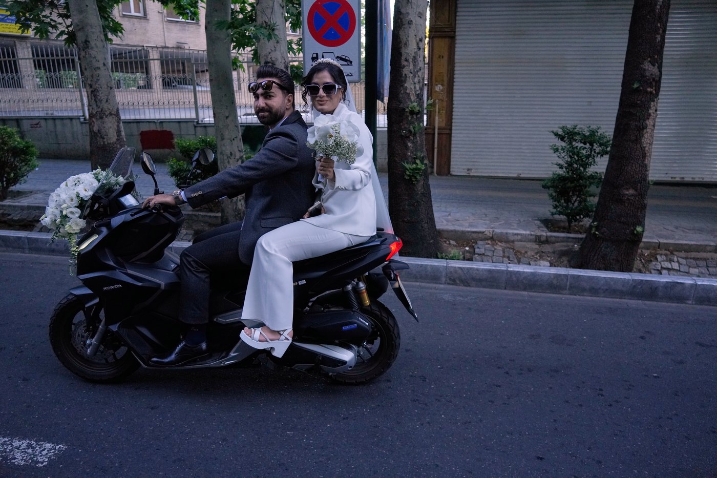 A groom and bride ride on their motorbike in northern Tehran, Iran, Friday, May 1, 2026. (AP Photo/Vahid Salemi)