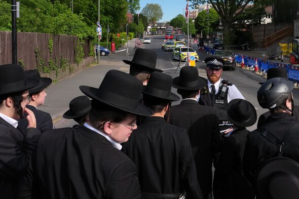 Members of the Jewish community stand behind cordon at Golders Green stabbing incident