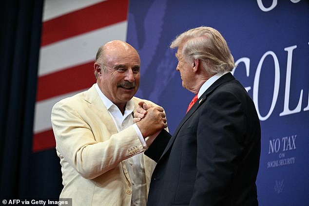 Dr Phil (left) was beckoned onstage by President Donald Trump (right) during his Friday afternoon event at the Villages in Florida