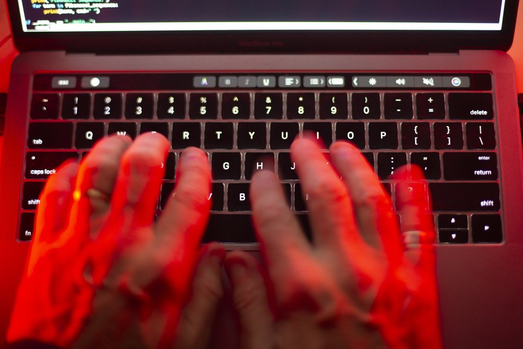 FILE - A man uses a laptop in Toronto in this Sunday, Oct. 9, 2023, photo illustration. THE CANADIAN PRESS/Graeme Roy