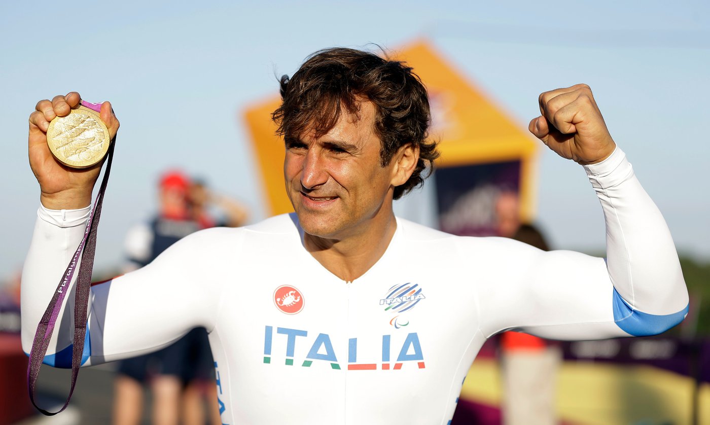 FILE - Alessandro Zanardi of Italy celebrates holding his gold medal following the medal ceremony for the man's road cycle individual time trial H4 category at the 2012 Paralympics games, Wednesday, Sept. 5, 2012, at Brands Hatch motor racing circuit near London. (AP Photo/Alastair Grant, File)