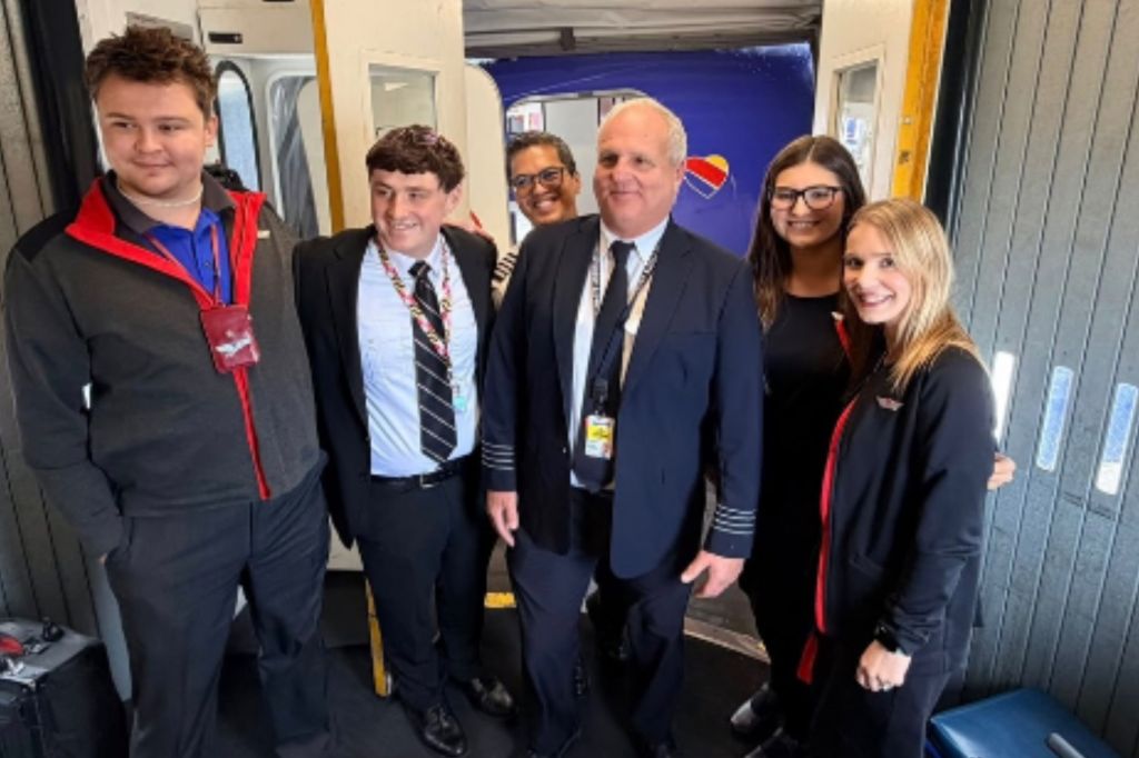 Retiring Spirit Airlines Captain Jon Jackson, third from right, is given a send-off by Southwest Airlines crew after his last flight was called off
