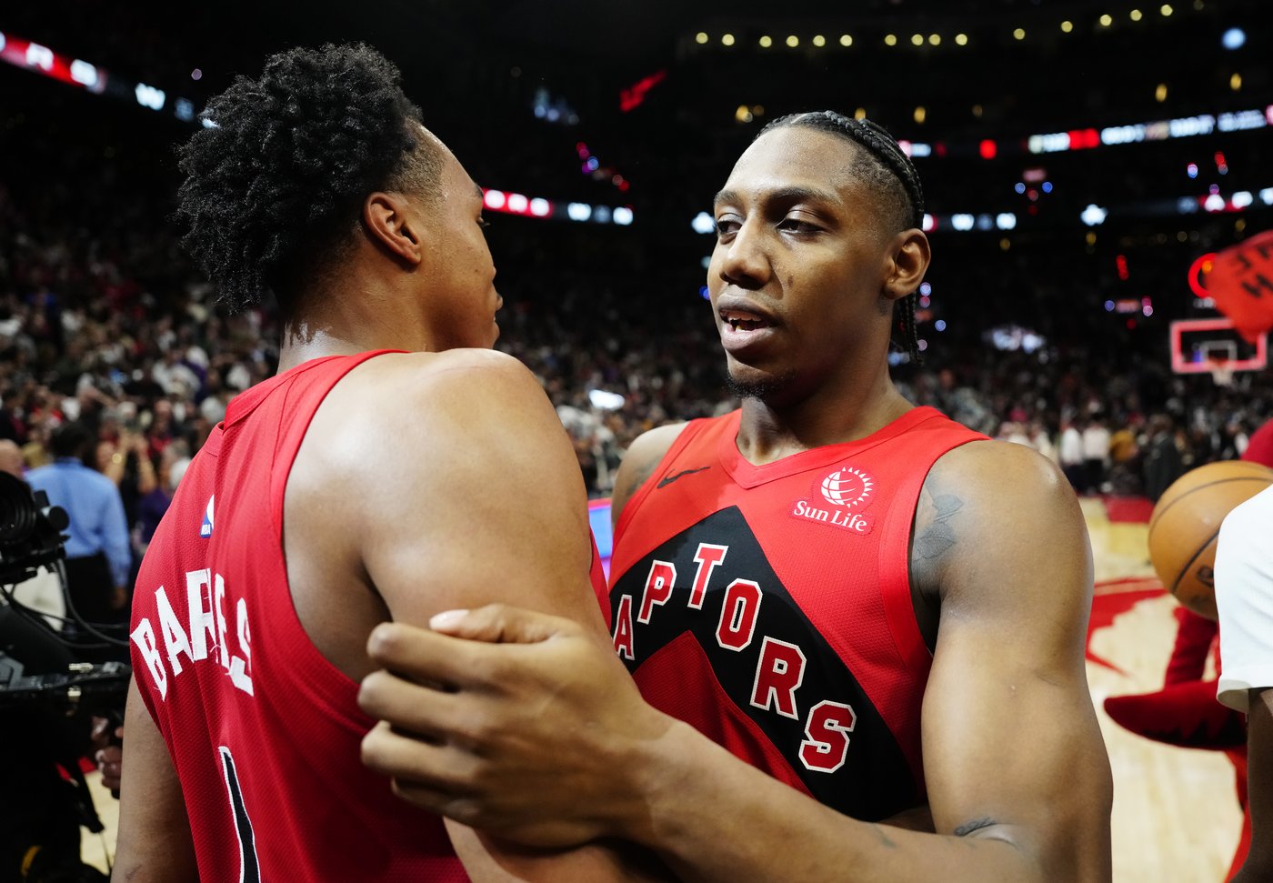 Toronto Raptors' RJ Barrett (right) celebrates with Scottie Barnes (4) after defeating the Cleveland Cavaliers in overtime NBA playoff basketball action in Toronto on Friday, May 1, 2026. THE CANADIAN PRESS/Frank Gunn