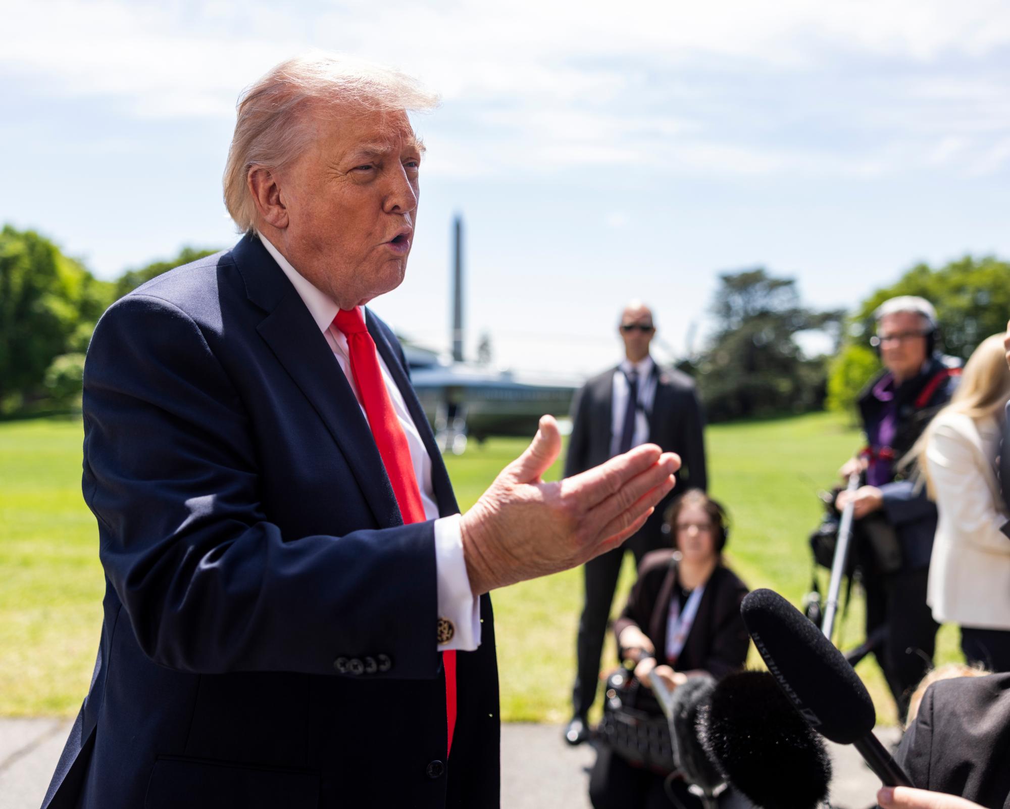 Donald Trump speaks to reporters as he leaves the White House for Florida on 1 May.