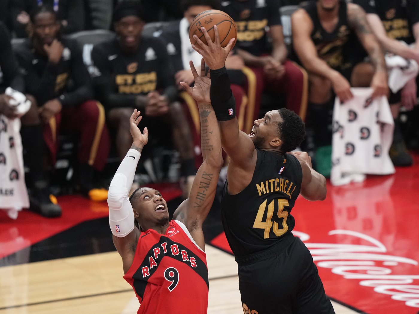 Raptors swingman RJ Barrett (9) and Cleveland Cavaliers guard Donovan Mitchell (45) battle for the ball during NBA playoff basketball action in Toronto on May 1, 2026. THE CANADIAN PRESS/Nathan Denette