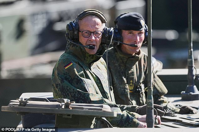 German Chancellor Friedrich Merz (L) and the Inspector of the Army Christian Freuding pictured sitting in a GTK Boxer tank at the German army barracks in Munster, northern Germany, on April 30