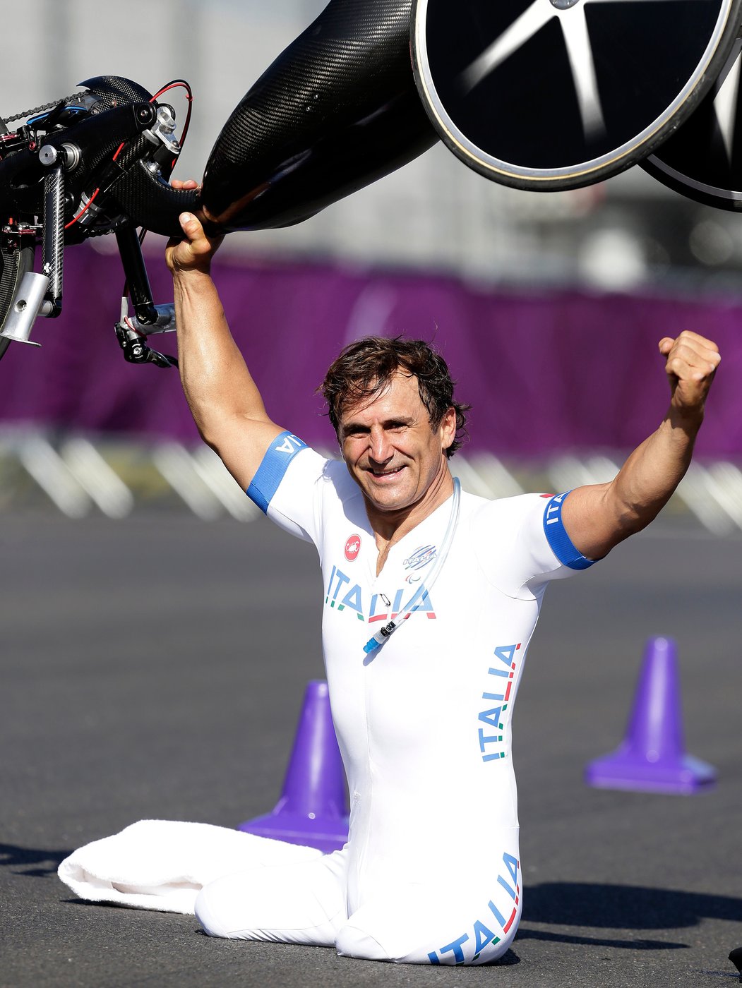 FILE Alessandro Zanardi of Italy celebrates winning the gold medal after he competed in the man's road cycle individual time trial H4 category at the 2012 Paralympics games, in London., Wednesday, Sept. 5, 2012. (AP Photo/Alastair Grant, File)