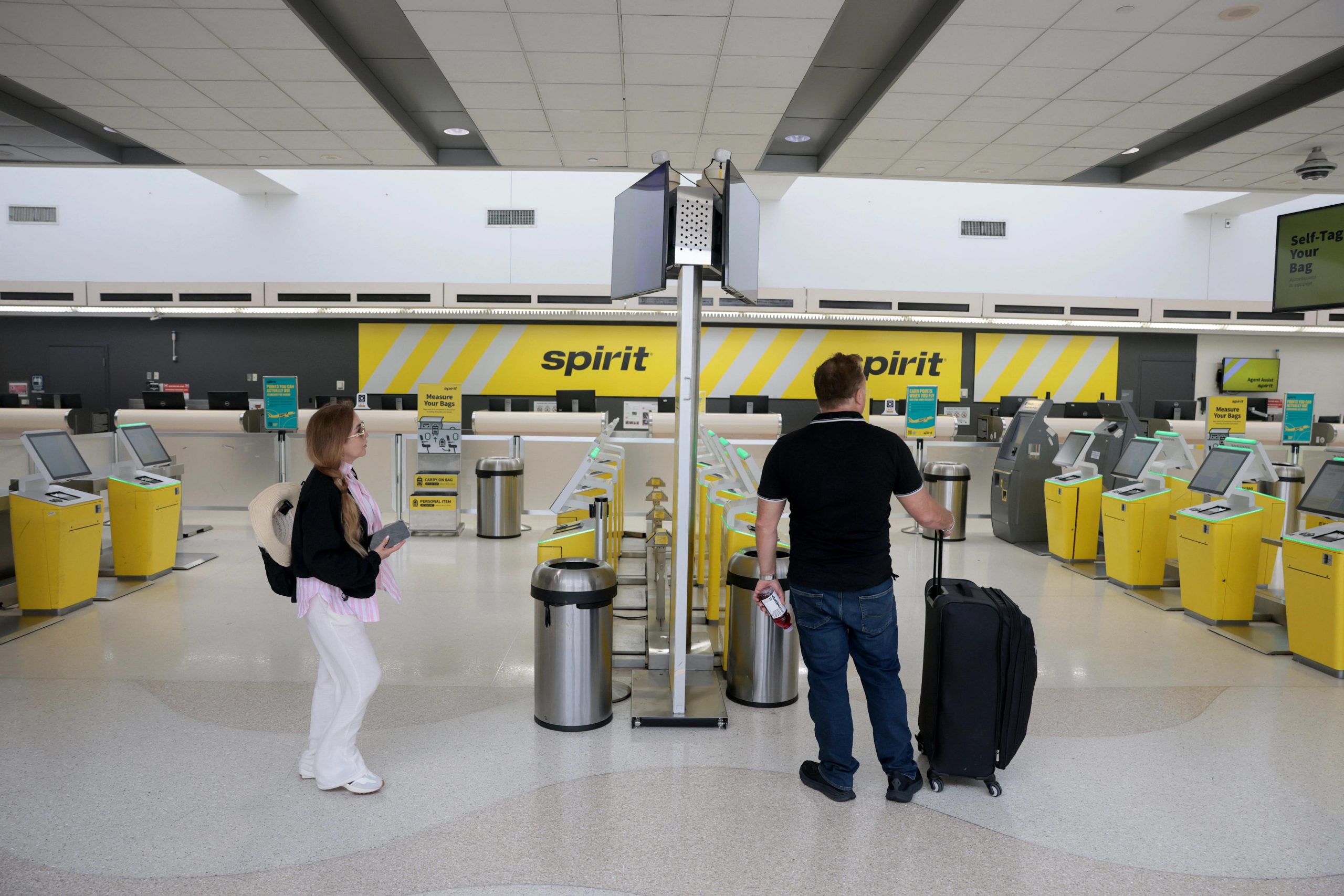 Rosmy Ramirez prepares to check in for her flight on Spirit Airlines to Texas before realizing it was canceled when the company shut down overnight at the Fort Lauderdale-Hollywood International Airport on May 02, 2026, in Fort Lauderdale, Florida.