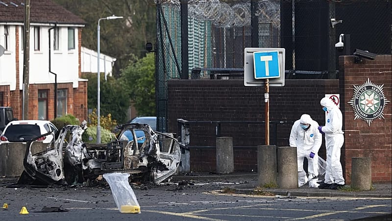 Forensic Scene Investigators inspect the remains of a car bomb that exploded outside Dunmurry police station in South Belfast, Sunday, April 26, 2026. (AP Photo/Peter Morrison