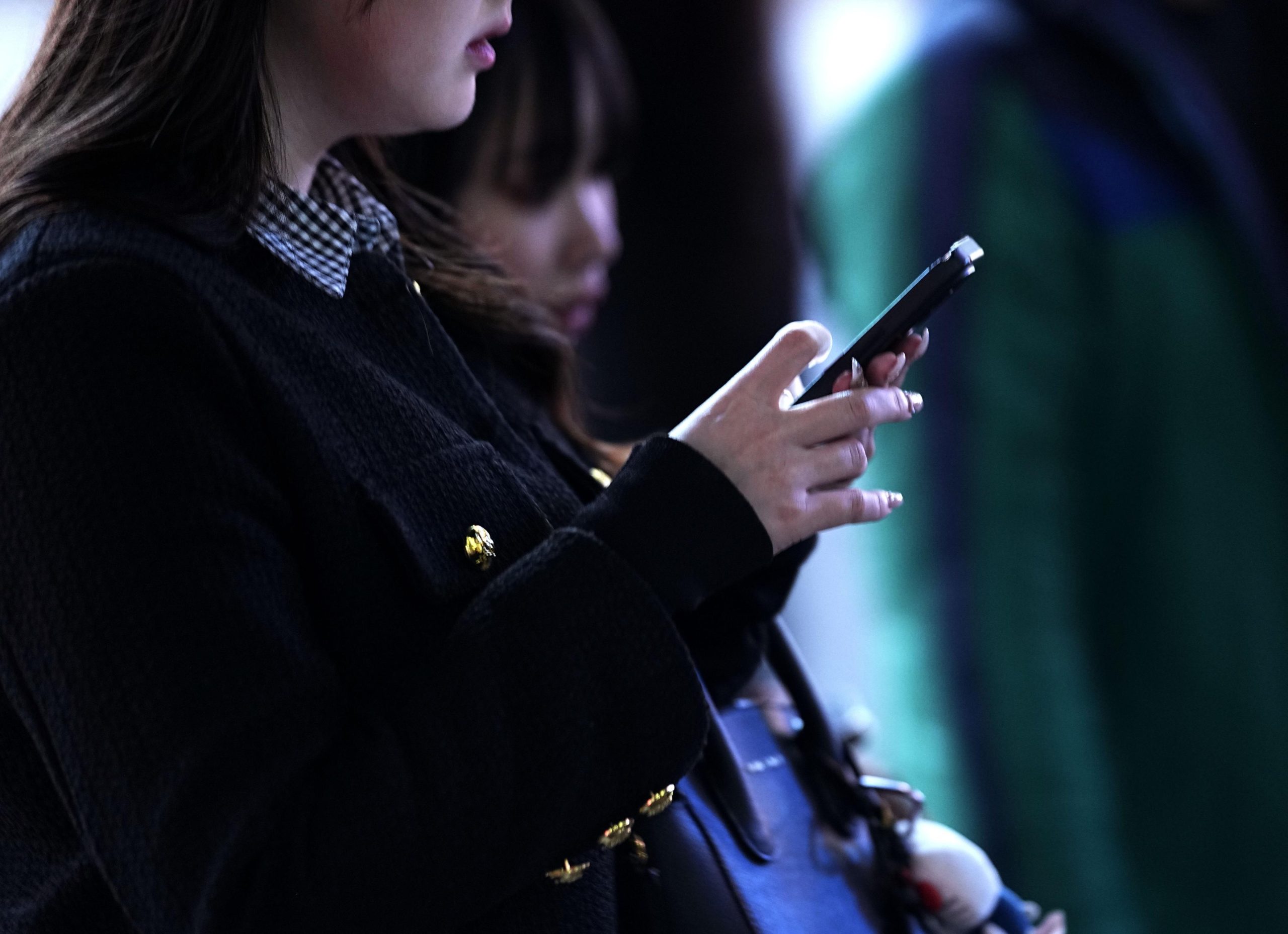 Photo taken on Feb. 20, 2025, shows a person with a smartphone in Tokyo. (Photo not for sale)(For editorial use only)(Kyodo)