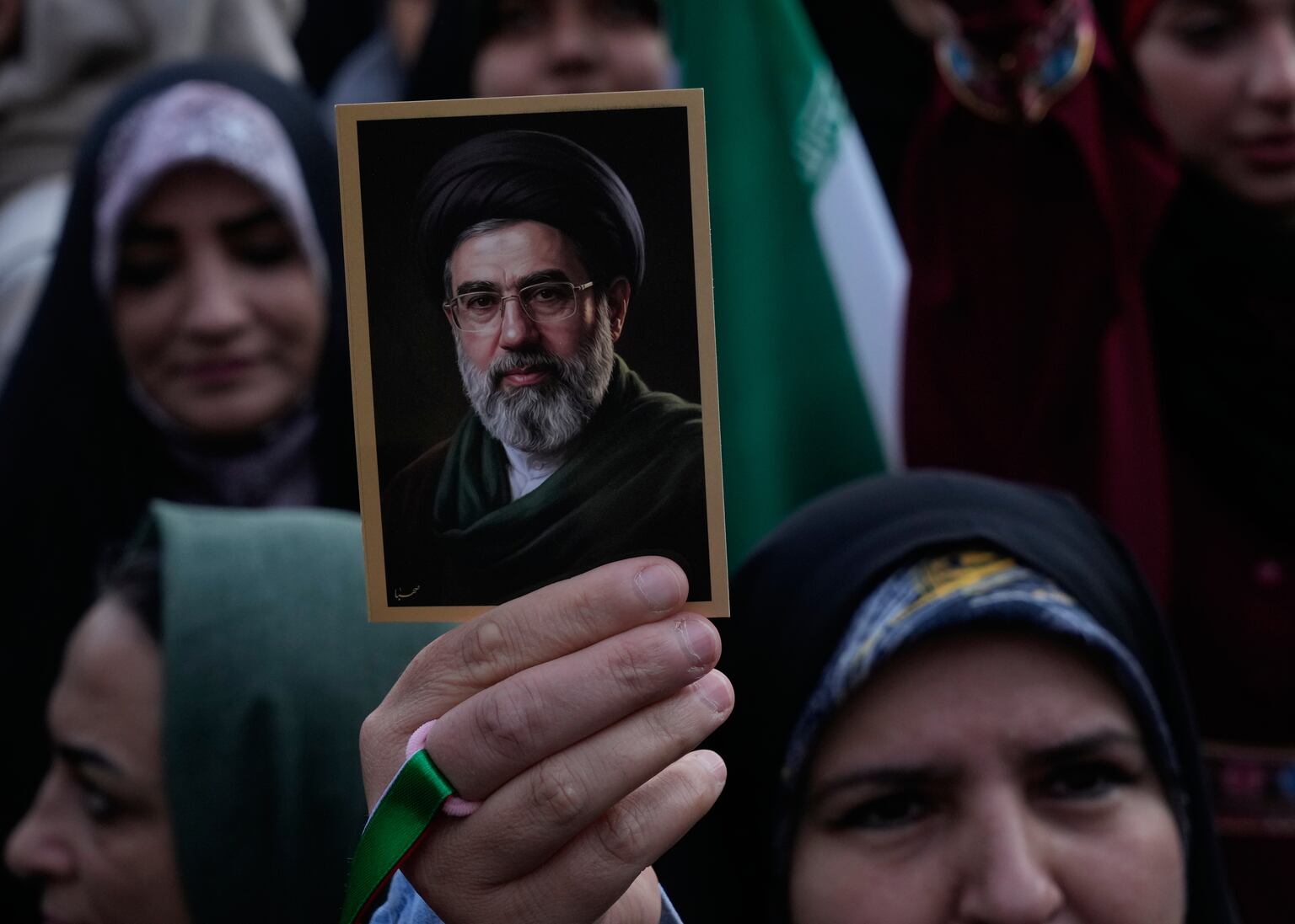 A woman holds up a picture Ayatollah Mojtaba Khamenei during a state-organised rally in Tehran (Vahid Salemi/AP)